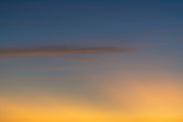 The dramatic colors of the sunset in the sky gradient from blue to orange.