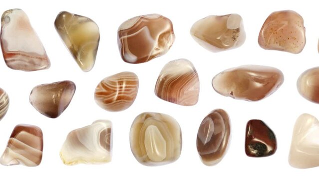 Persian agate stones set texture on white light isolated background. Moving right seamless loop backdrop.