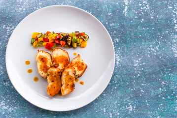 Healthy food grill chicken sweet pepper eggplant in white plate on blue wood background.