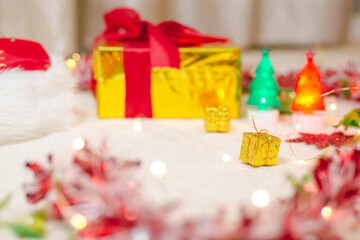 Christmas tree with lights and gift boxes on carpet floor