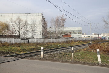 Fototapeta na wymiar Railway crossing in tje industrial area, Moscow, November 2022.
