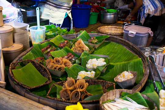 Thai karen ethnic people cooking traditional local food snack tribe for sale traveler travel visit and eat drink goods products in oh poi local market bazaar at Suan Phueng city in Ratchaburi Thailand