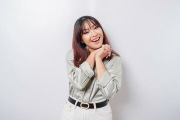 Fototapeta premium A portrait of a happy Asian woman wearing a sage green shirt isolated by white background