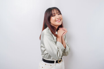 A portrait of a happy Asian woman wearing a sage green shirt isolated by white background