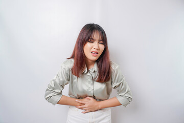 Photo of young unwell sick ill woman hold hand on stomach suffers pain isolated on white background