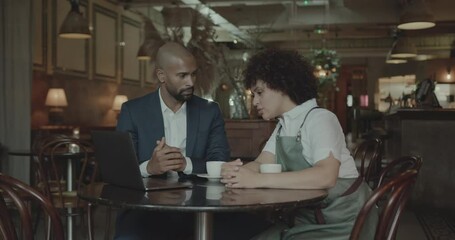 Chef and Restaurant Owner talking with Financial Advisor Investor