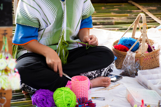 Karen ethnic working embroidery knitting yarn lanna style in handmade craft shop in oh poi local market bazaar for thai people and foreign travelers travel visit at Suan Phueng in Ratchaburi, Thailand