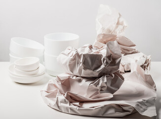 Unpacking new ceramic whiteware. Paper packaging for fragile items. Ecological packaging