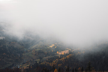 Autumn foggy landscape. Beautiful mountains view in the morning.