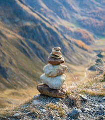 Stacked pile of stones high up in the mountains overlooking the valley.