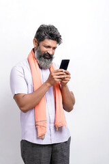 Indian farmer using smartphone on white background.