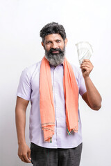 Indian farmer showing money on white background.