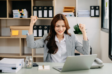 Woman are delighted and happy with the work they do on their tablet, laptop and taking notes at the office..