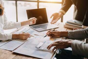 Business team collaboration discussing working analyzing with financial data and marketing growth report graph in team, presentation and digital tablet, laptop.