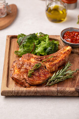 Portion of gourmet beef tomahawk steak with salad and sauce