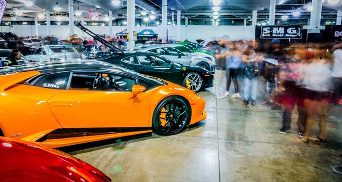Crowd looking at Lamborghini Huracan in a row with other cars at Hot Import Car Show in Honolulu