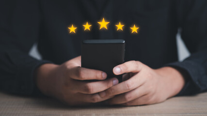 Close up of man customer giving a five star rating on smartphone. Using technology for Review, Service rating, satisfaction, Customer service experience and satisfaction survey concept.