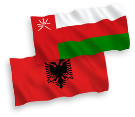 National vector fabric wave flags of Sultanate of Oman and Albania isolated on white background. 1 to 2 proportion.