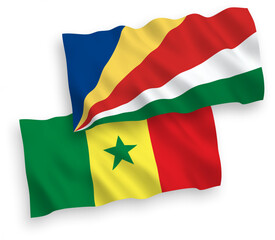 Obraz premium National vector fabric wave flags of Republic of Senegal and Seychelles isolated on white background. 1 to 2 proportion.