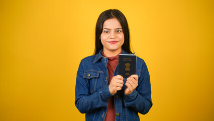 Young woman holding Indian passport, isolated over colour background, Beautiful girl holding visa