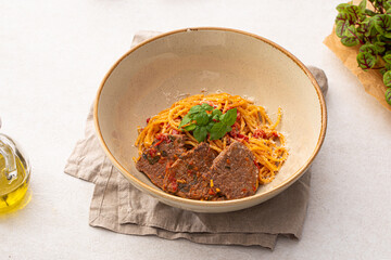 Portion of gourmet spaghetti pasta arrabbiata with roast beef