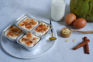 homemade coconut custard cake topped with almond slices and cinnamon 
