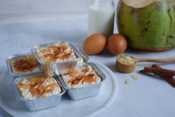 baked coconut custard cake or klappertaart with almond slices toppings 