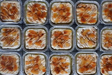 homemade coconut custard cake or klappertaart topped with almond slice and cinnamon 