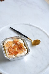  a cup of baked coconut custard cake or klappertaart in white background 