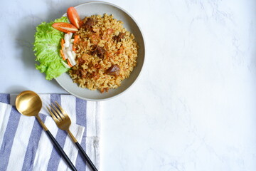 a plate of fried rice with meat 