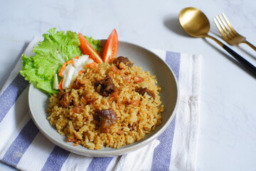 a plate of fried rice with meat 