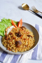 a plate of fried rice with meat 