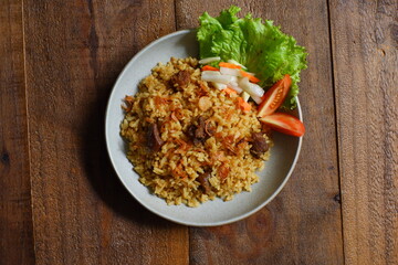 a plate of fried rice with meat 