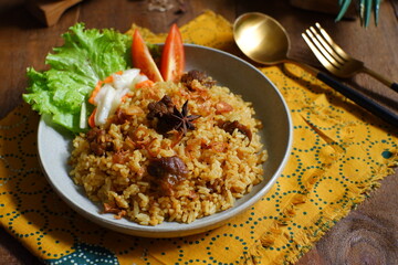 a plate of fried rice with meat 