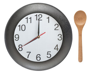 Clock on the plate and wooden spoon isolated