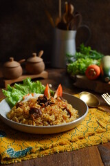 a plate of fried rice with meat 