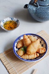 a plate of fried banana pastry 