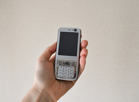 Old mobile phone with hand.