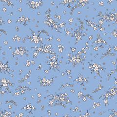 Vintage pattern of small white wildflowers on a blue background.