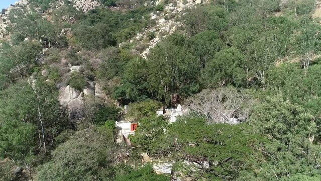 Historical antaragange temple hidden in green forest and rock boulders