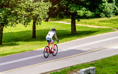 Naklejka premium Cyclist ride on the bike path in the city Park 