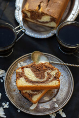 Slices of marble cake with coconut served with coffee