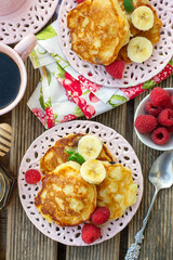 Sweet fruit pancakes with apples, bananas and raspberries