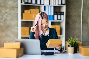 Young asian Woman Thinking and Working on sell online in cozy house, Modern Lifestyle of New Generation People.