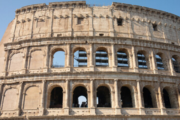 Obraz premium Coliseum (Colosseum), Rome, Italy. Ancient Roman Coliseum is famous landmark, top tourist attraction of Rome. Scenic view of Coliseum with blue sky.