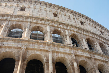 Obraz premium Coliseum (Colosseum), Rome, Italy. Ancient Roman Coliseum is famous landmark, top tourist attraction of Rome. Scenic view of Coliseum with blue sky.