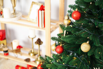 Christmas tree and shelving with Christmas accessories, space for text