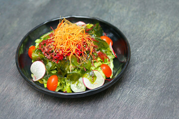 Mix seaweed and vegetable salad, Healthy foo in black plate.