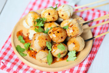 Meatballs on plate with with spicy sauce, Grilled meatball and pork ball, Meat ball on skewers and fresh coriander vegetables, Thai food Asian food Meat balls - pork balls