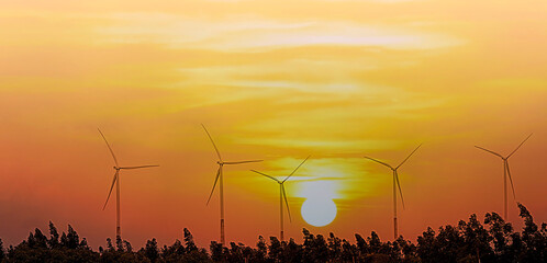 Sunset view with of clean energy at Solar panels with wind turbines generating electricity - Alternative renewable energy concept